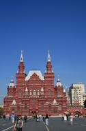 People on the Red Square, near the beautiful and colorful Kremlin in Moscow, Russia, under the blue sky