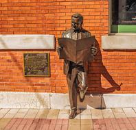 bronze statue with newspaper in ybor city