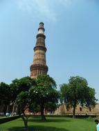 castle with a tower on a green hill in india