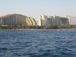 Buildings on the shore of Eilat, Israel, among the green trees