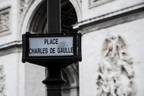 Black and white photo with the beautiful landmark sign in Paris, France, near the architecture