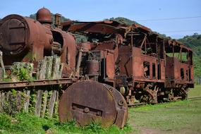 Old train among the green plants in Paranapiacaba, Brazil, under the blue sky