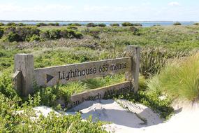 sign on the beach, lighthouse