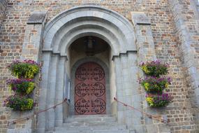 flowers near the arched entrance to the church building