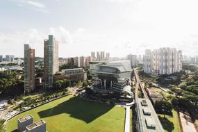 urban architecture, green lawns and trees