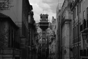 Black and white photo of the beautiful street with the buildings, in Lisbon, Portugal