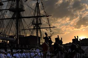 silhouettes of sailors on a warship in the morning in boston