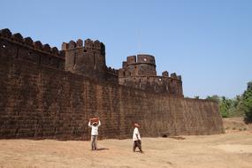 people near the ruins of an ancient building in india