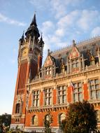 brick building of the town hall with a tower in france