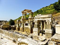 Beautiful ruins in sunlight, among the colorful plants, in Turkey, under the blue sky