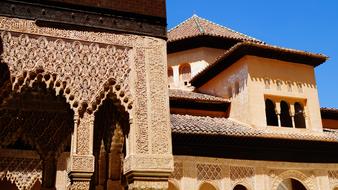 Beautiful building with patterns, in sunlight, in Granada, Spain, under the blue sky