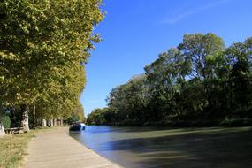 boat on channel in park at summer, France, languedoc-roussillon