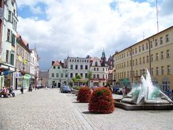 Beautiful town square of Zary, Lubusz, Poland, with fountain, buildings and colorful plants