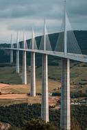 Bridge on the pillars, above the colorful and beautiful mountains with the fields