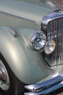 Headlights of silver Vintage Car close up