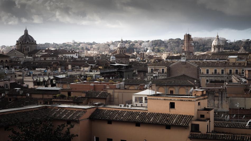 Beautiful cityscape of the city, with the colorful roofs, under the sky with clouds