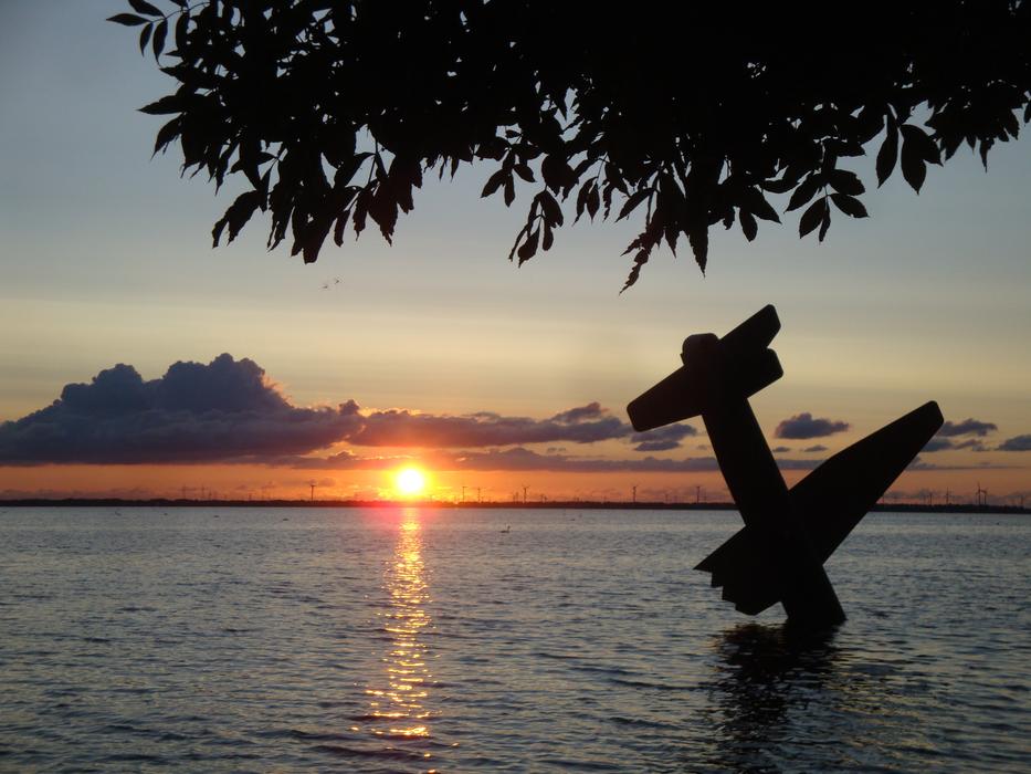War memorial in the water, in the water in Harderwijk, Netherlands, at colorful and beautiful sunset