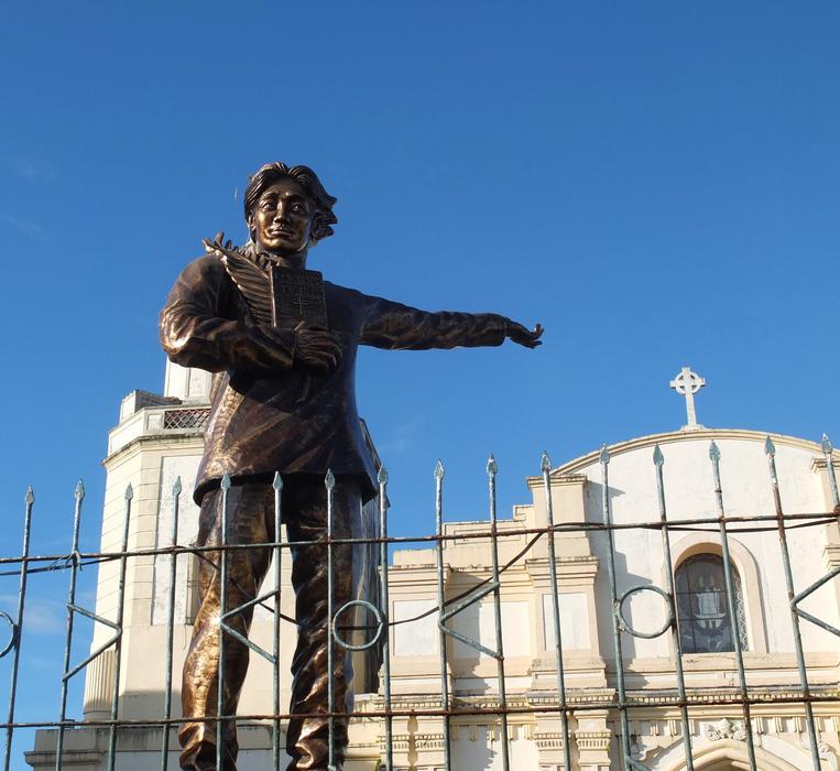 statue of a man near the church