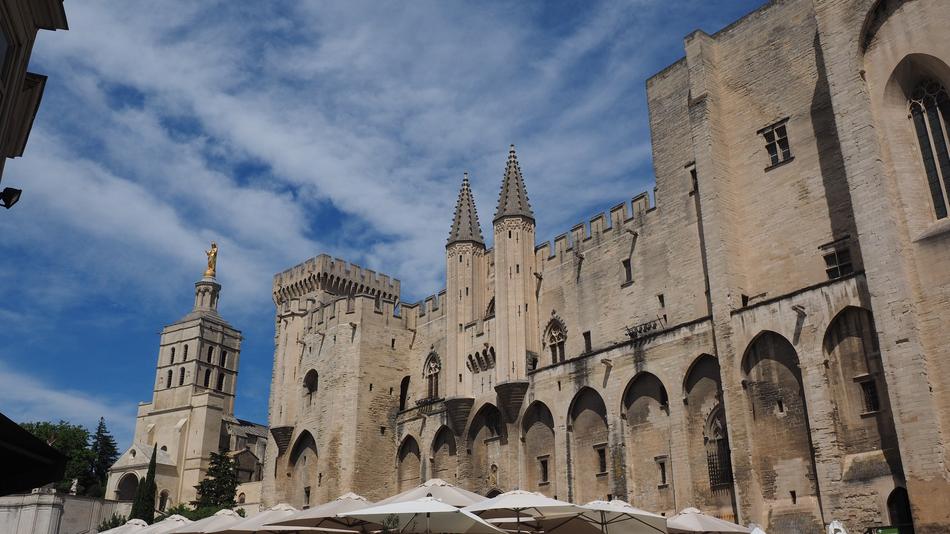 Beautiful Palais Des Papes in Avignon, France, at blue sky with clouds on background