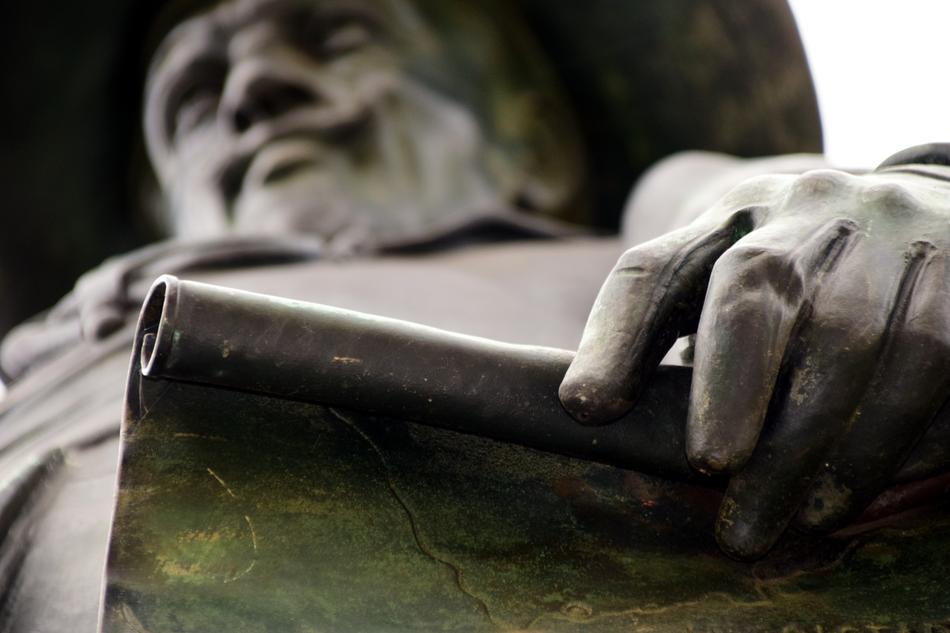Bronze statue of the man, with the map, in Bavaria, Swabia, Germany