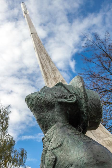 sculpture of a man near a rocket