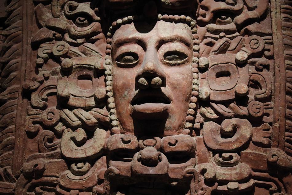 Beautiful, carved face in the museum in light in Mexico