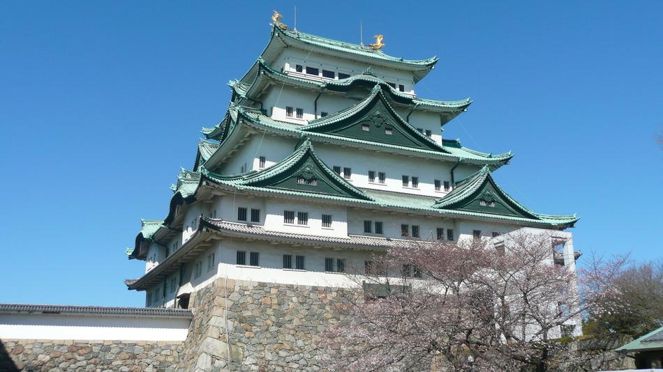 Beautiful, green and white castle in Japan, under the blue sky