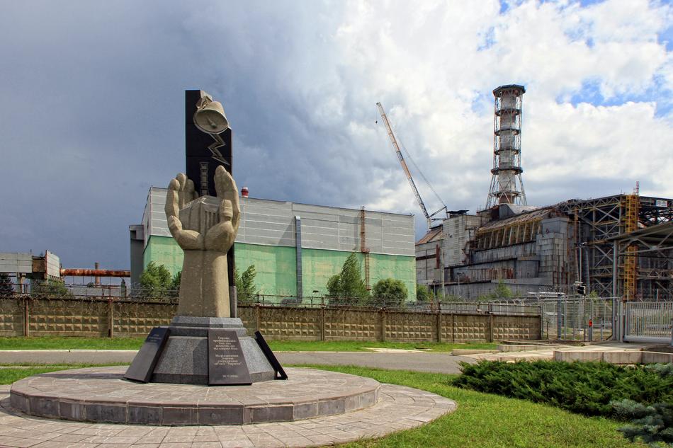 Monument in Chernobyl, Ukraine, among the green plants, under the cloudy sky