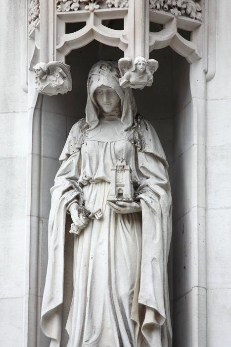 Beautiful, white statue in the patterned arch in Westminster Abbery, London, Britain