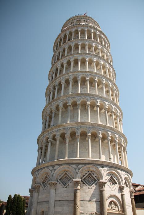 Beautiful Pisa Tower with the columns in Pisa, Italy, under the blue sky