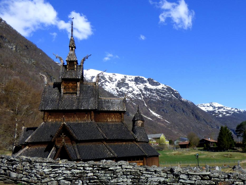 wooden medieval church on a background of snowy mountains