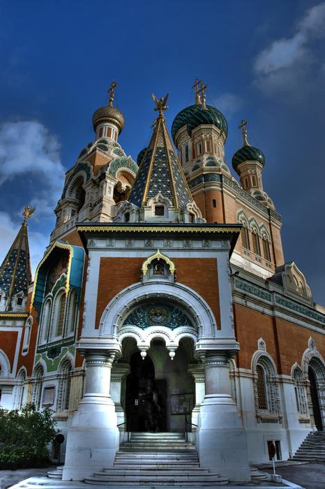 Beautiful and colorful Russian basilica with decorations, under the blue sky with clouds