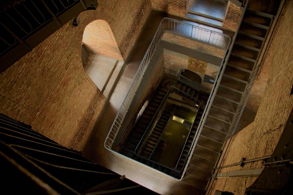 Beautiful, old spiral staircases in the tower with windows with light