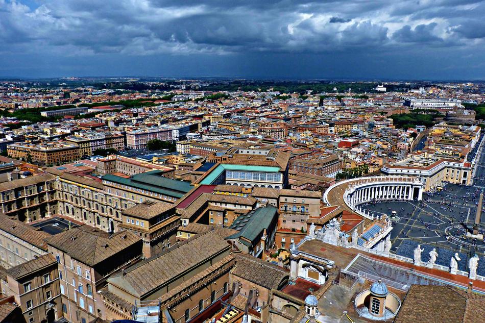 Beautiful and colorful buildings and Sistine Chapel in Vatican, under the clouds