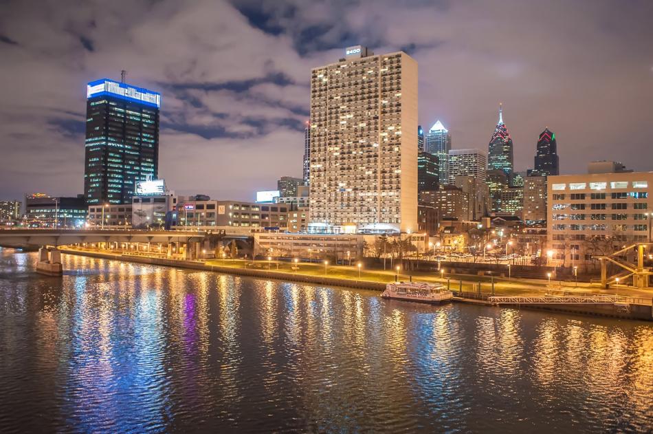 Shore of the city in the North America, with the colorful lights, under the sky with clouds