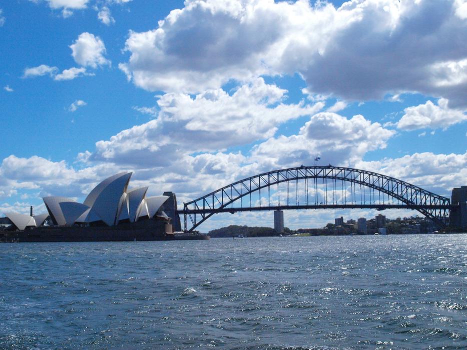 Landscape of the harbour of Sydney, Australia, in sunlight, under the blue sky with clouds