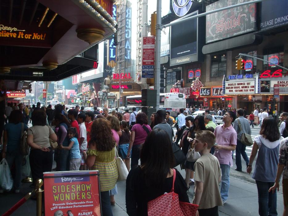 a crowd of people in front of a theater in New York