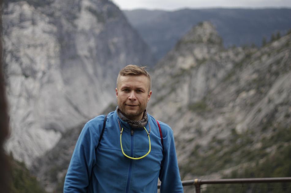 Man, at background with the beautiful Yosemite Mountains with green plants, in California, USA