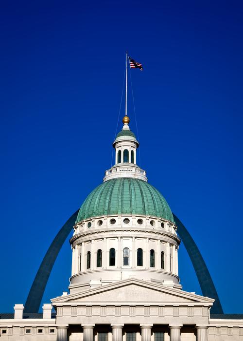 Beautiful city hall with dome, with the flag, in St Louis, Missouri, USA, under the blue sky