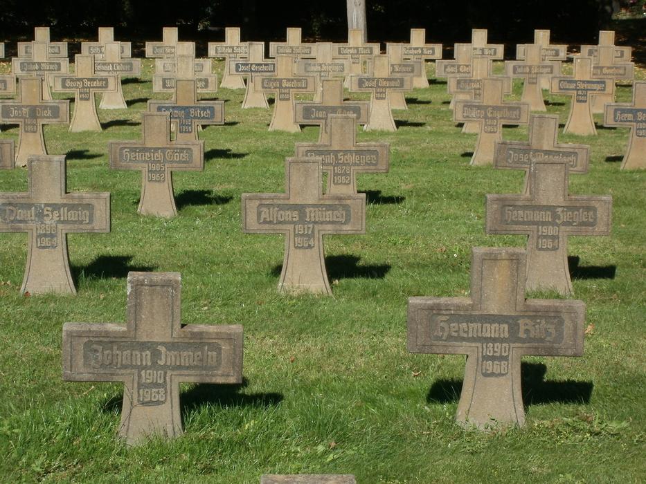 Cemetery of the veterans with tombs and green grass in sunlight, in Bruehl, Germany