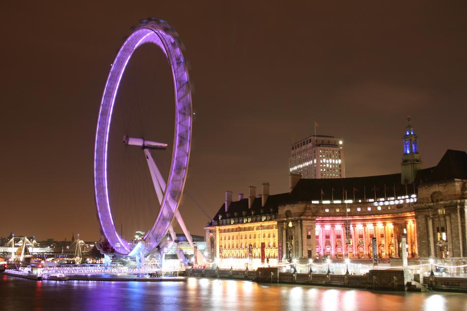 Beautiful Shore of London, England, with the buildings and London Eye with colorful lights, at the night