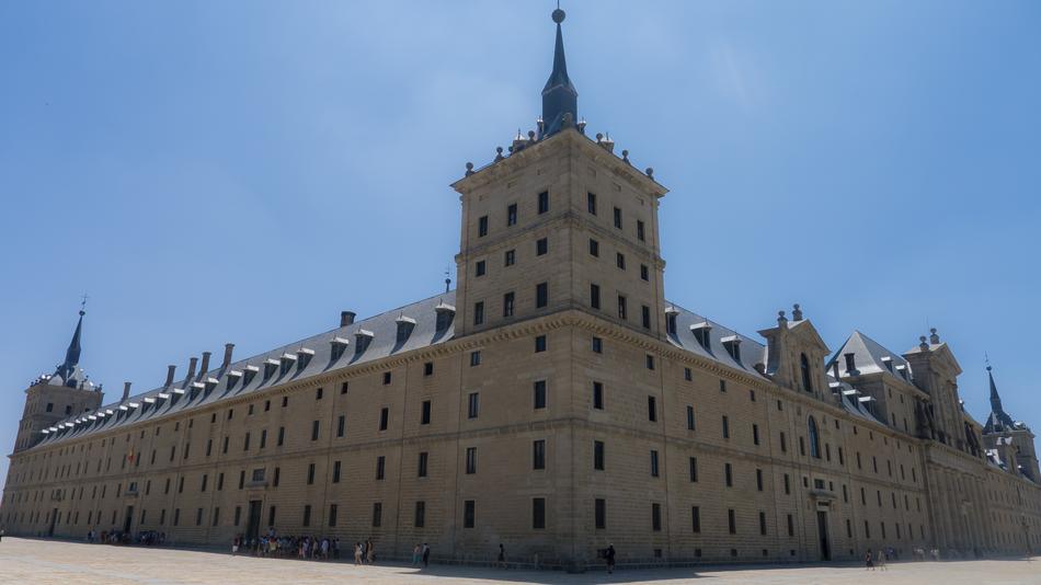 Building with the towers in Spain, in sunlight, under the blue sky