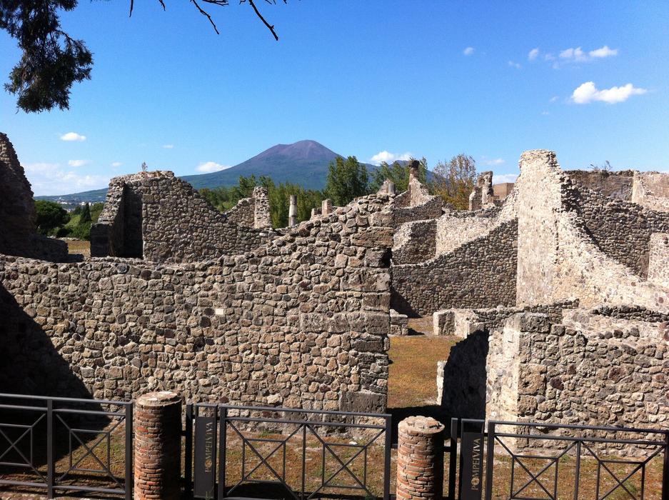 Beautiful and colorful ruins of Pompeii in sunlight, among the plants, near the mountain, in Italy