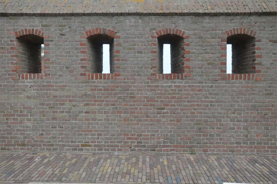 Embrasures in historical brick battlement