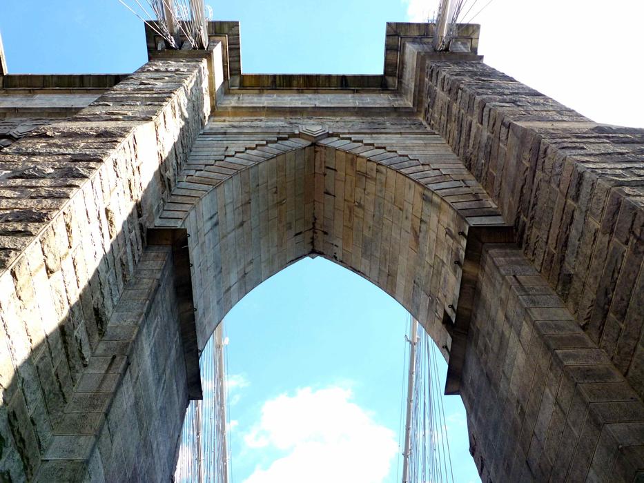 Beautiful Brooklyn Bridge in New York, USA, under the blue sky with clouds