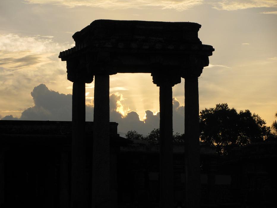 Silhouette of the beautiful architecture with columns in Belur, India, at colorful and beautiful sunset