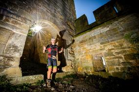 traveler with a flashlight in a medieval castle in the south of France