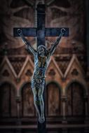 bronze Crucifixion at gothic wall