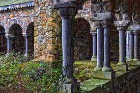 Beautiful, old, colorful church with the columns and colorful garden