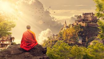 monk meditates on a background of clouds and a castle on a mountain